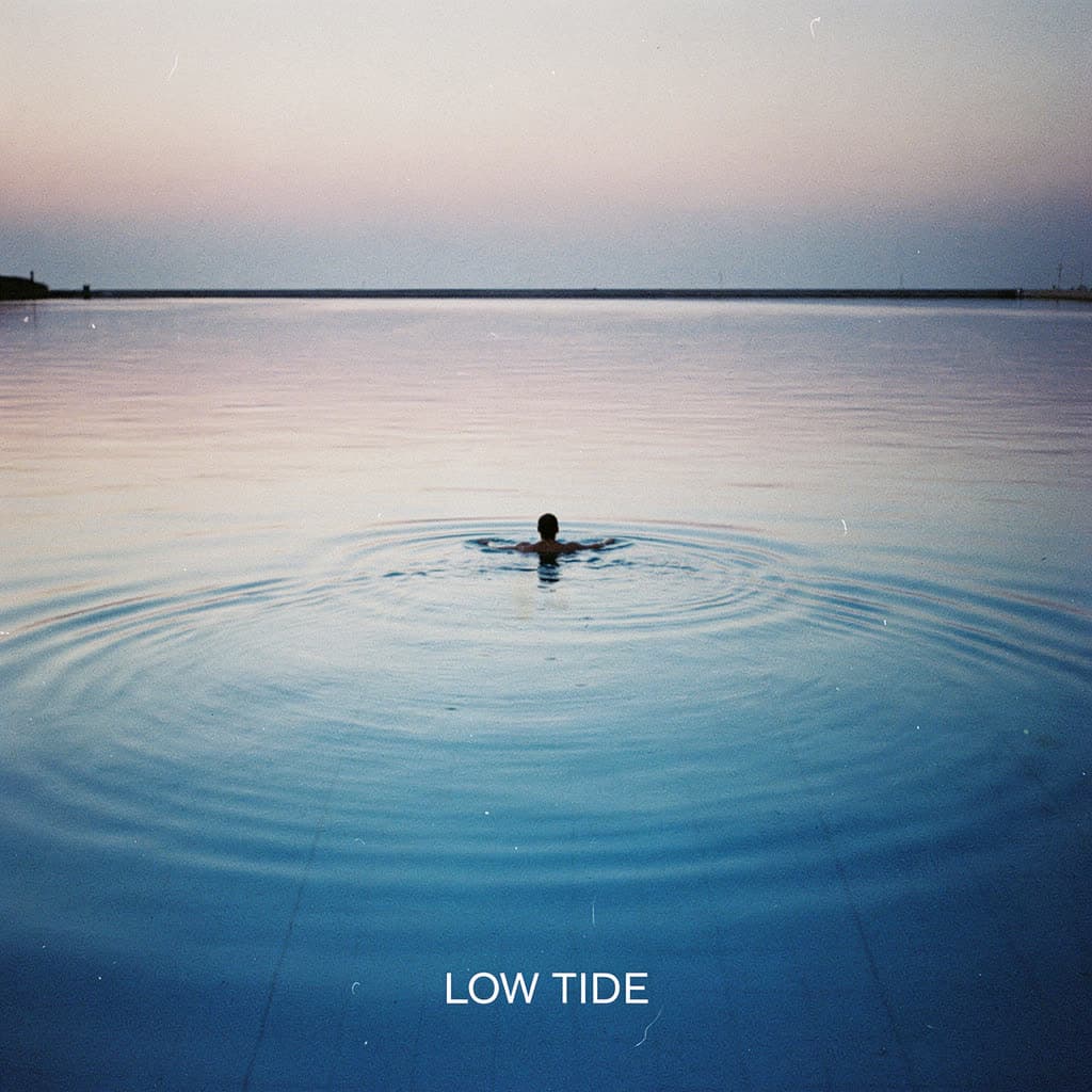 An album cover called Low Tide: one swimmer in a flat, pale sea